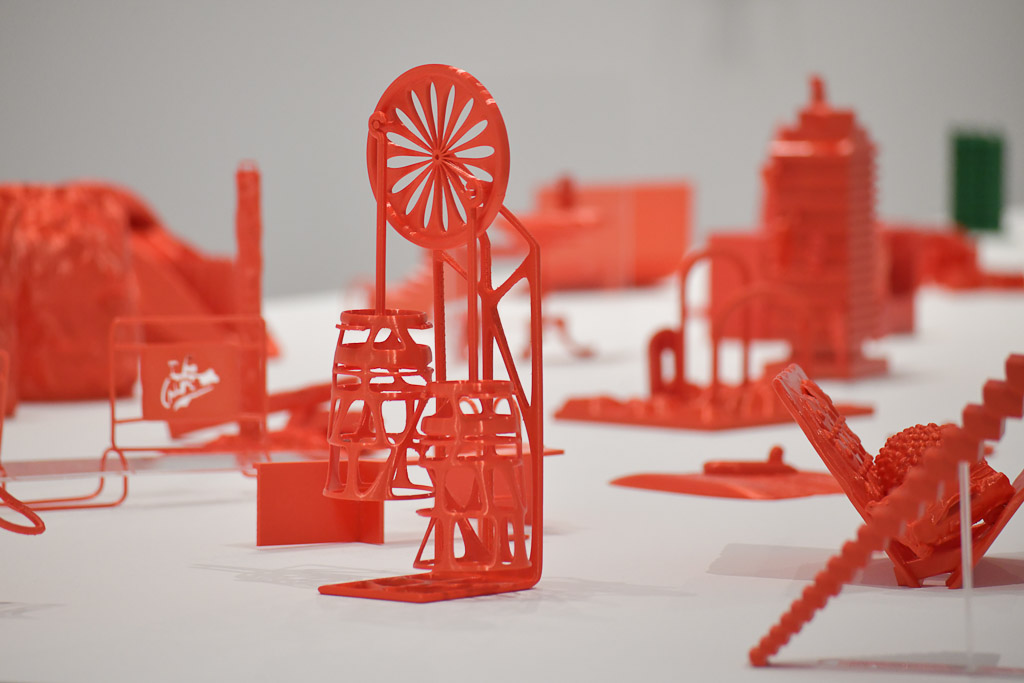 Rote Papierskulptur mit Industriemotiven auf einem Tisch