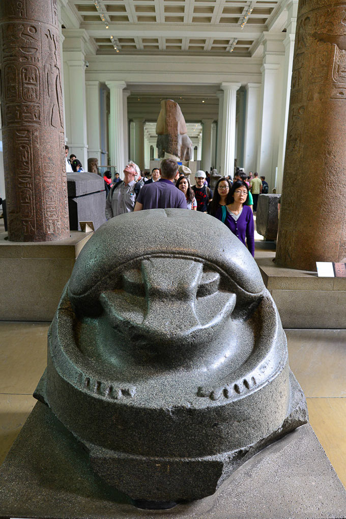 Antike Steinskulptur vor Säulen im Hochformat