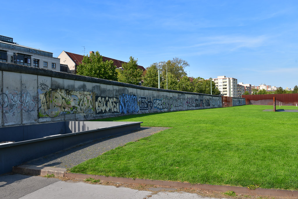 Mauerstück mit Graffiti am Grünstreifen
