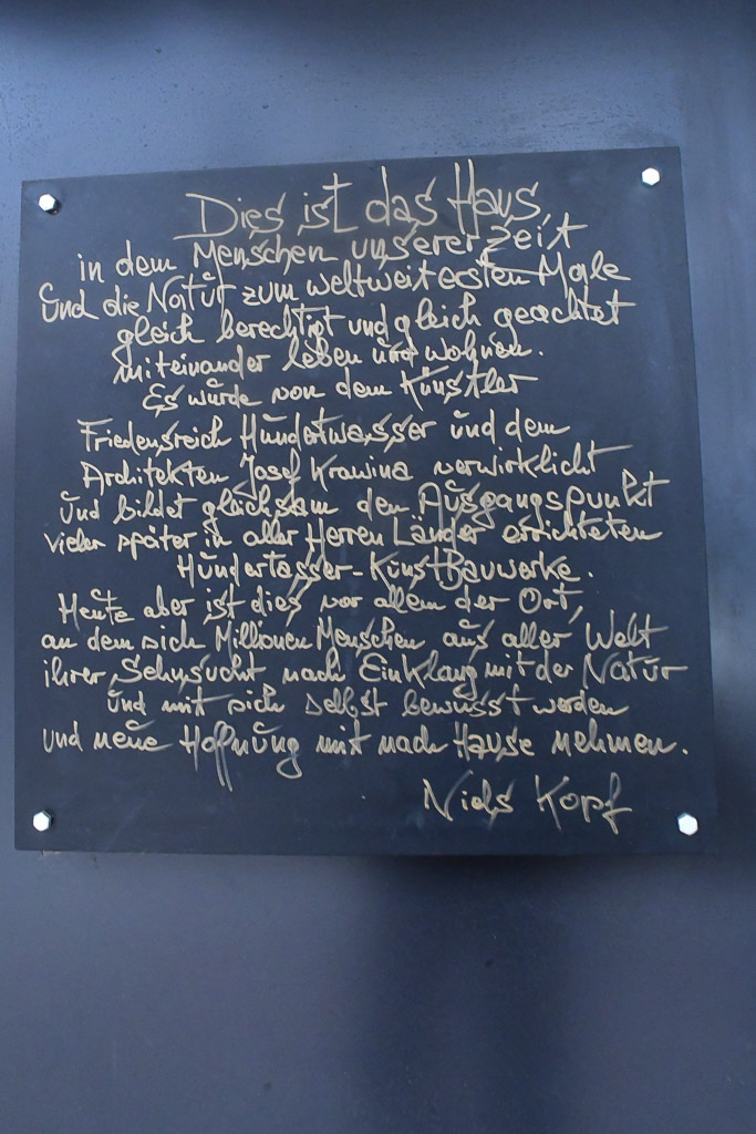 Gedichttafel an einer Wand im Hochformat