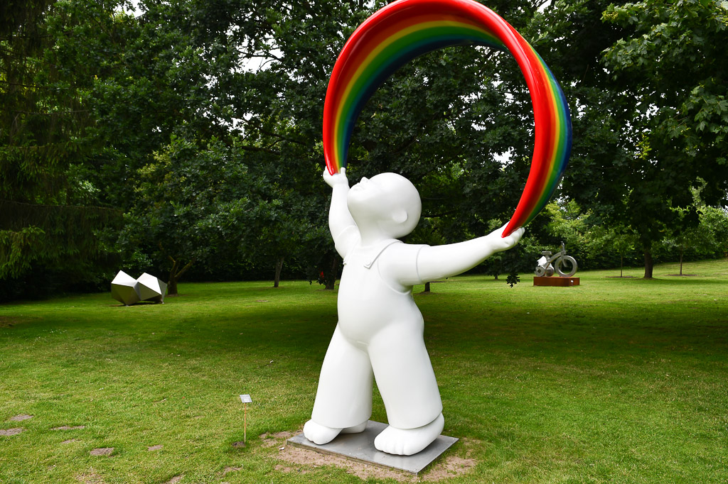 Weiße Figur mit Regenbogen