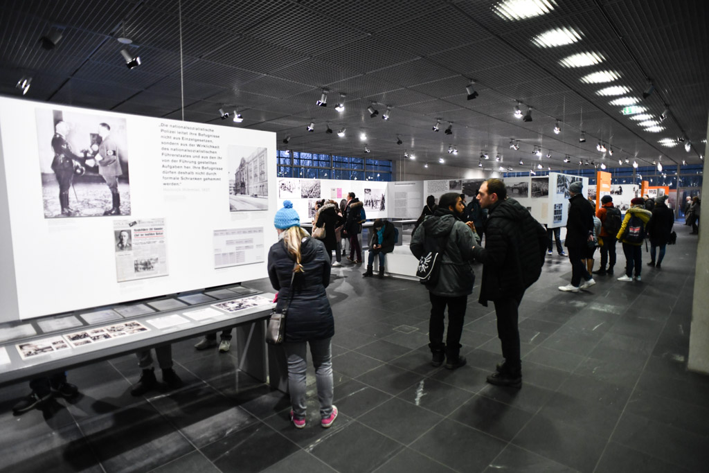 Ausstellungstafel mit Besuchern