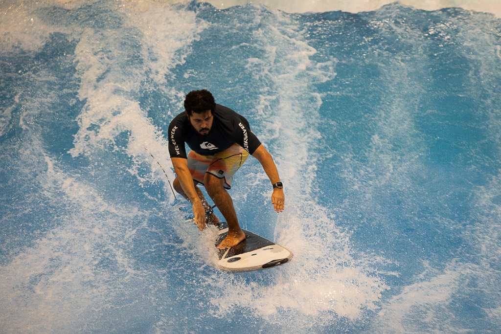 Surfer mit schwarzem Shirt auf der Welle